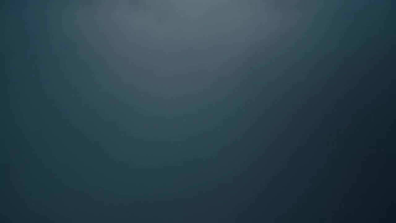 Frame from an AI-generated aerial video of a waterfall canyon
